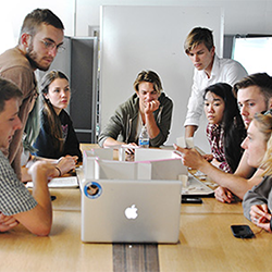 group of people around laptop